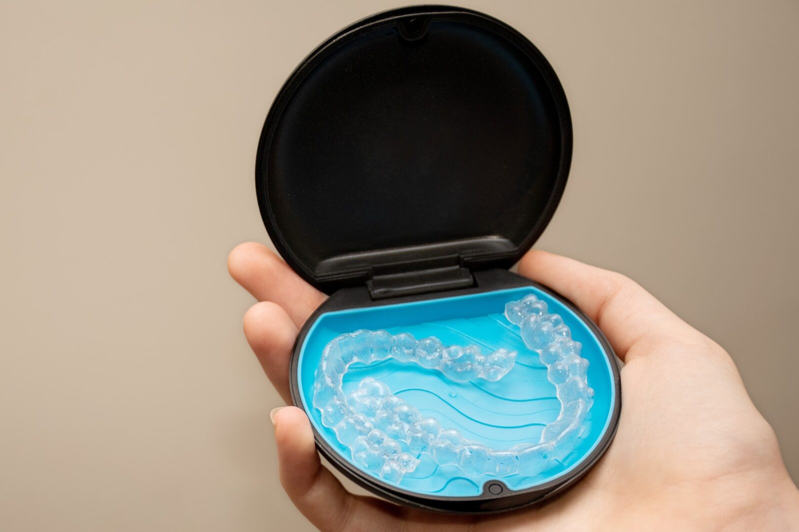 Teeth aligners in a storage case. Invisible braces. Clear teeth straighteners. Clear plastic braces